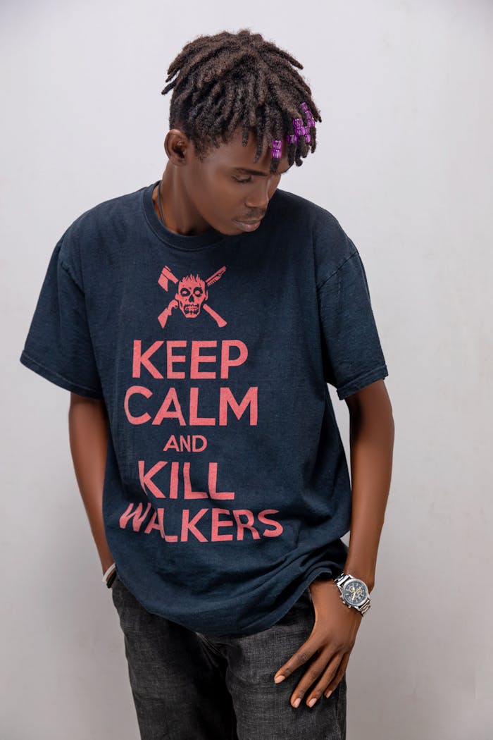 services-img Young man posing in a graphic T-shirt with 'Keep Calm and Kill Walkers' print.